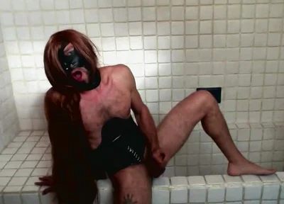 Long Hair Sissy in Corset Uses Gagball in Bathroom