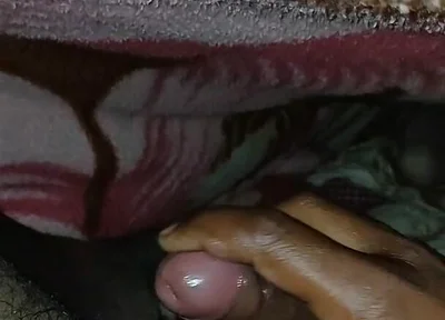 Big Boss massaging penis oil under the blanket