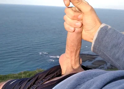 Huge Dirty Cock Gets Handjob on the Beach and Squirts a Lot of Thick Sperm in Front of the Beach