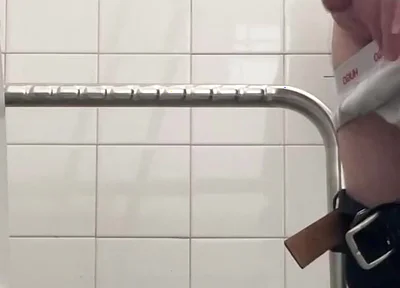 In the Hospital Toilets, a Guy Pisses Into a Cup for a Urine Sample, Then Gets Horny, Jerks-off and Cums