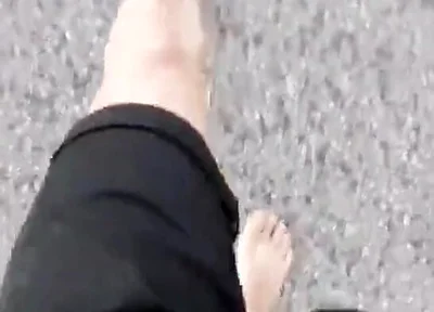 Jon Arteen Walks Barefoot on the Street Outdoors, the Boy Is Barefoot in the Crowded Tram to the Town Center