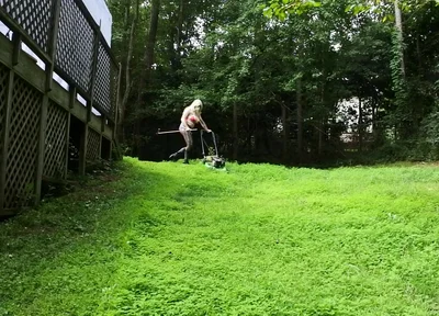 Big Fake Tits Crossdresser in Daisy Dukes Mowing Grass