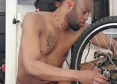 Kennie Jai Does a Nude Bike Repair. Watch That Big Dick Swing!