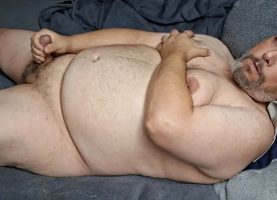 Chubby Guy Lays in Bed and Cums