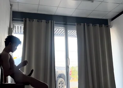 A Handsome Young Man Jerks off in Front of a Glass Door