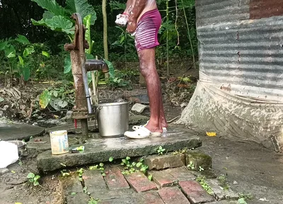 Black mature man bath in desi style. Showing big dick.
