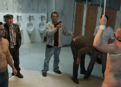 The Wrestler Gets Gang Banged by a Horny Crowd in a Public Restroom for Losing His Match.
