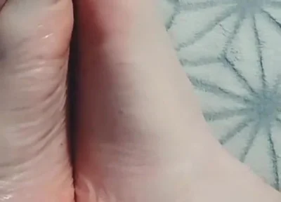 Guy Gently Massages His Feet with Oil